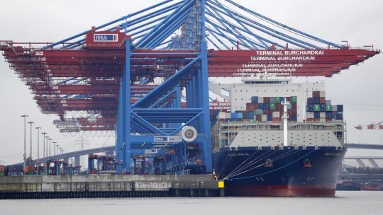 FILE - In this July 1, 2017 file photo containers are stacked on 'Zheng He' of China at the container terminal of the harbor of Hamburg, Germany. Germany's gross domestic product shrank in the third quarter of 2018, the first quarter-on-quarter decline since early 2015, which analysts said should be a wake-up call for Europe's largest economy. The Federal Statistical Office reported Wednesday, Nov. 14, 2018 that GDP shrank by 0.2 percent in the third quarter, in figures adjusted for price, seasonal and calendar variations, largely due to foreign trade developments.  (AP Photo/Matthias Schrader, file)